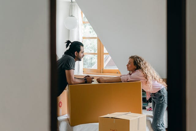 two tenants having a conversation with moving boxes between them